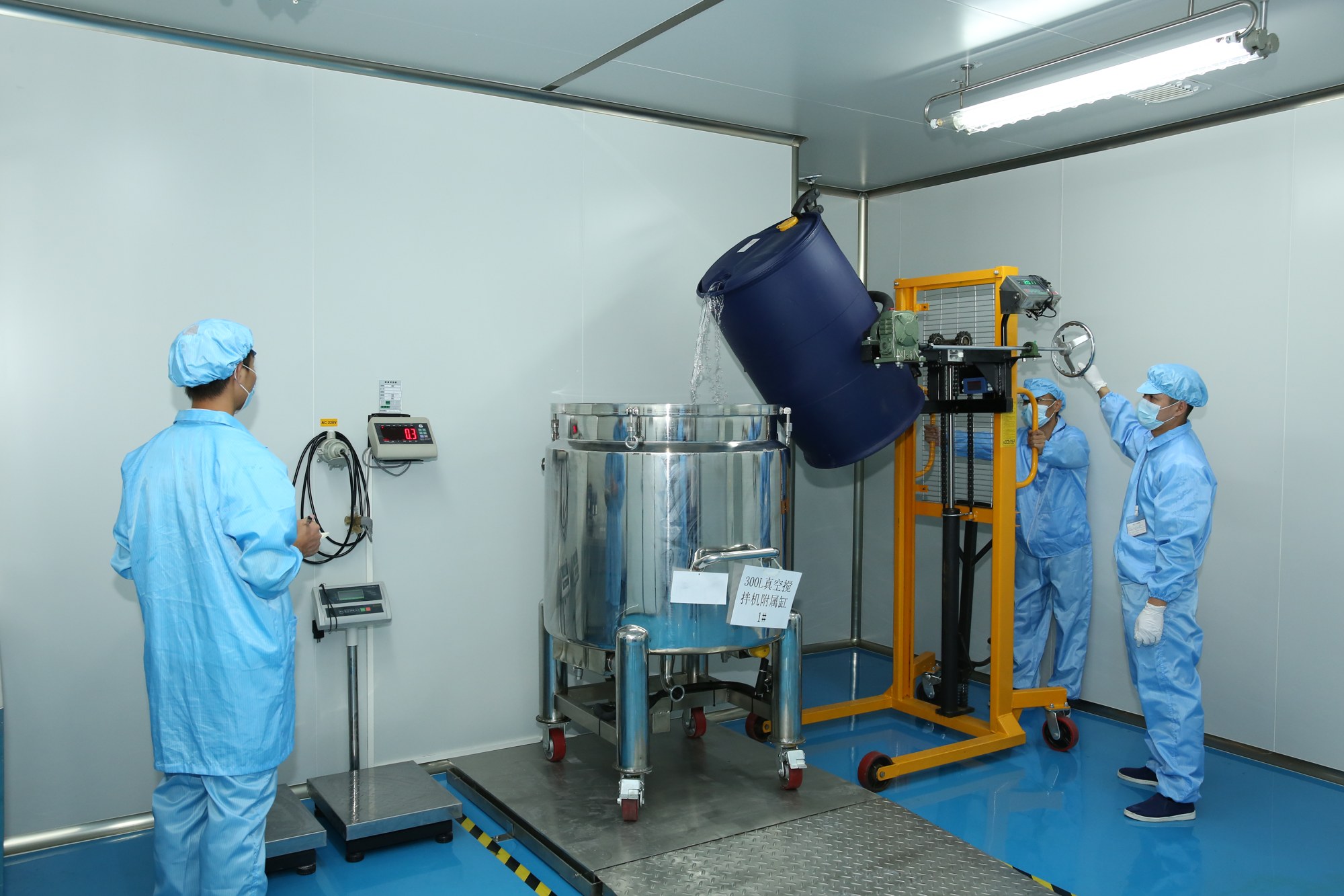 SUSANSAY production team loading material into nail gel mixing equipment