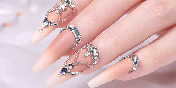 Raised crystal nail embellishments illustrating rhinestone adhesive applications