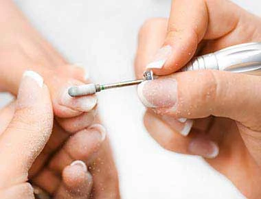 Professional filing of a nail enhancement